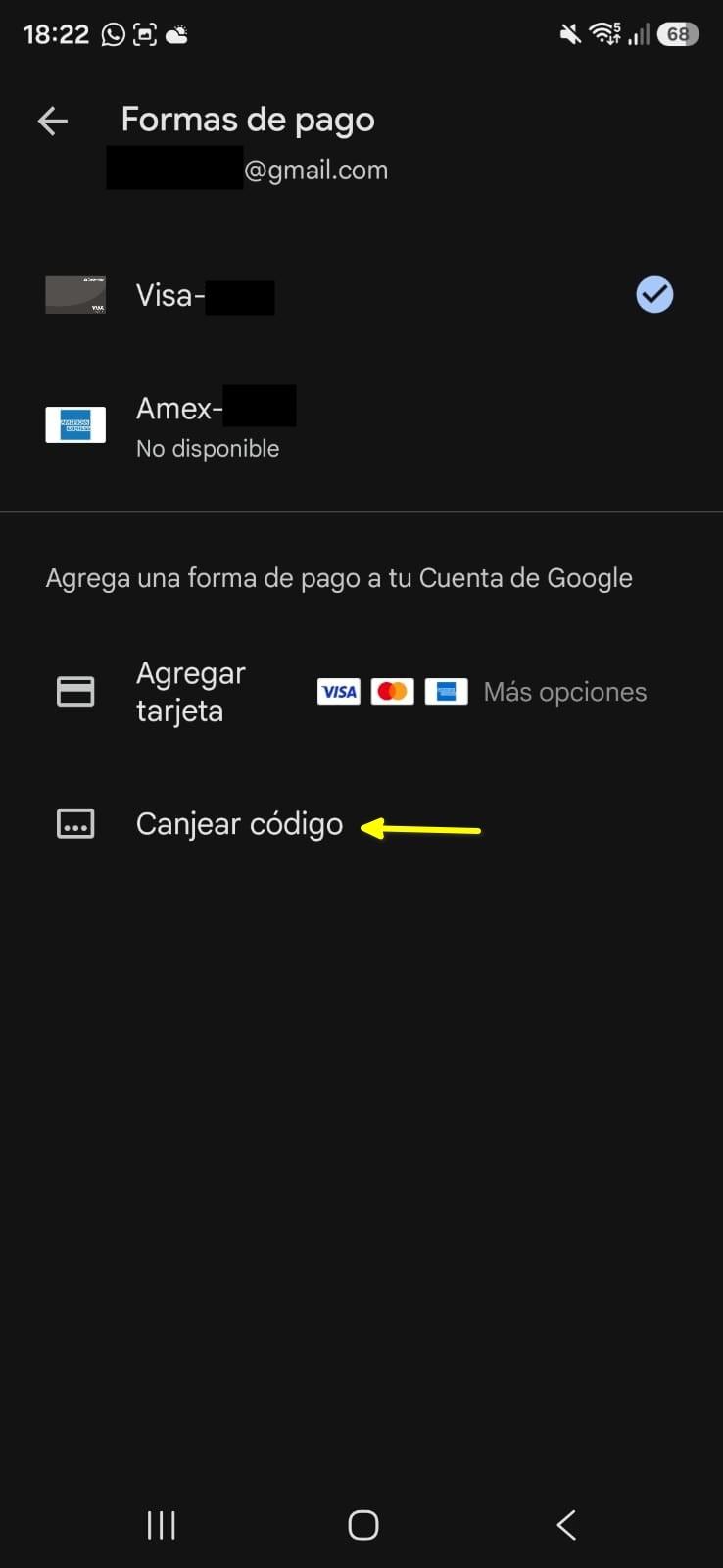 Menú de formas de pago de Google Play, con una flecha señalando Canjear código.